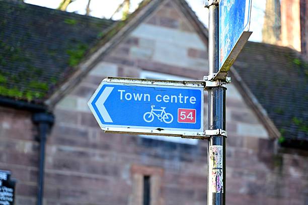 istock Blue cycling route sign to town centre left direction 2251616134