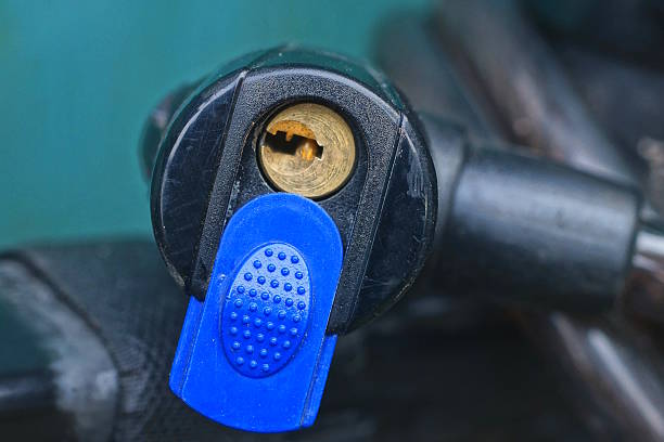 one black bicycle lock with a cable screwed on the metal frame of a sports bike