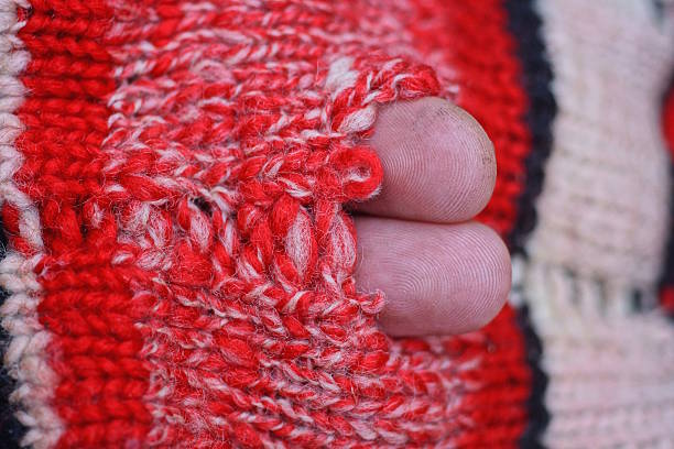 istock red white texture from an old woolen torn knitted fabric 2251616807