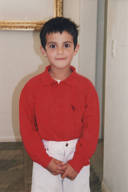 istock Image taken in 1988: smiling hispanic little boy looking at the camera posing at his home 2251621391