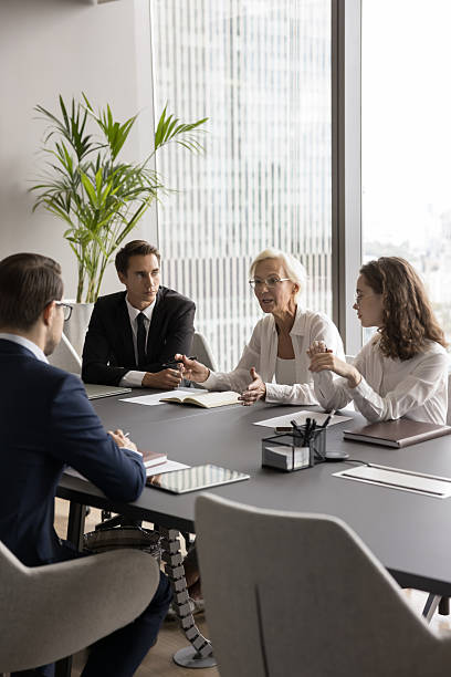 istock Serious businesswoman discuss project plan at group briefing in boardroom 2251622694
