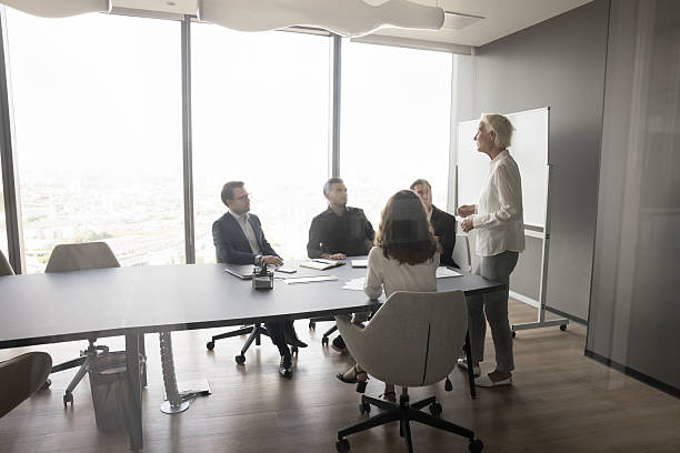 istock Businesslady explaining corporate goals, provide project details in boardroom 2251623046
