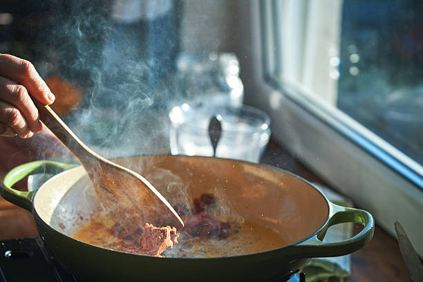 istock Preparing Thai Red Curry Served with Basmati Rice in Domestic Kitchen 2251624939
