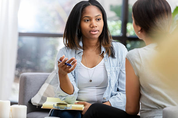 istock Psychologist or therapist having a serious conversation with a patient in a calming office setting. 2251630764