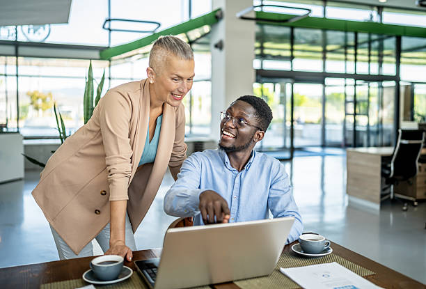 istock Business colleagues collaborating on laptop in modern office 2251632318