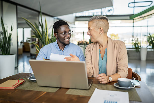 istock Business colleagues collaborating on project, reviewing documents in office 2251632327