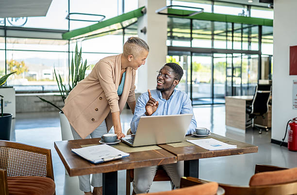 istock Business people collaborating on laptop in modern office 2251632400