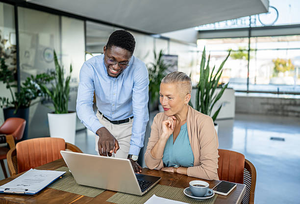 istock Diverse business professionals collaborating on laptop in office 2251632634