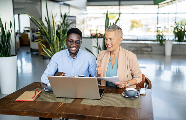 istock Diverse business professionals discussing work on laptop in office 2251632644