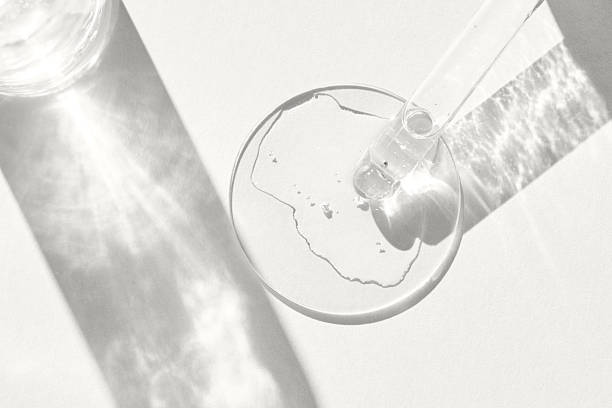 istock Transparent liquid in petri dish with dropper in sunlight patterns on white background 2251637084