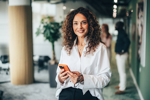 istock Elegant businesswoman using her phone 2251637452