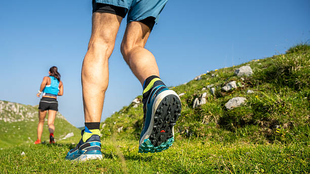 istock Runner in Blue Shorts and Vibrant Socks on a Grassy Hill 2251639847