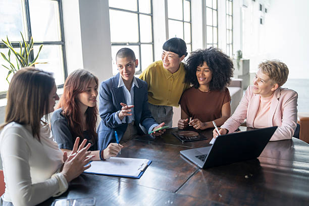 istock Diverse businesswomen collaborating on project in modern office 2251640254