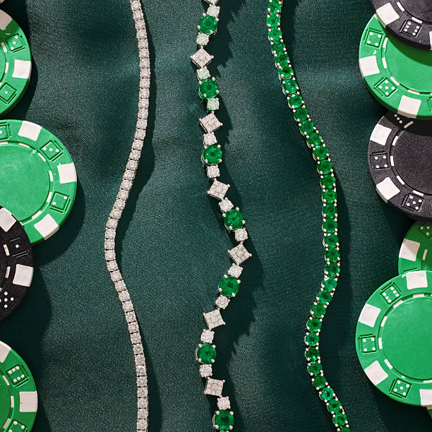 Luxurious emerald and diamond jewelry arranged beside green casino chips on deep green fabric, conveying glamour, wealth, and casino-inspired fashion for luxury branding and marketing materials.