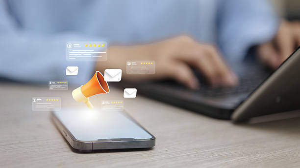 istock 3D megaphone and customer review stars on mobile phone screen. 2251642855