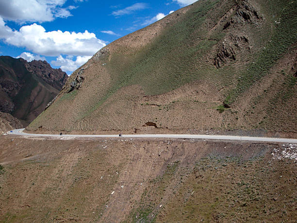 istock Mountainous Road with Minimal Vegetation and Cloudy Sky 2251644480