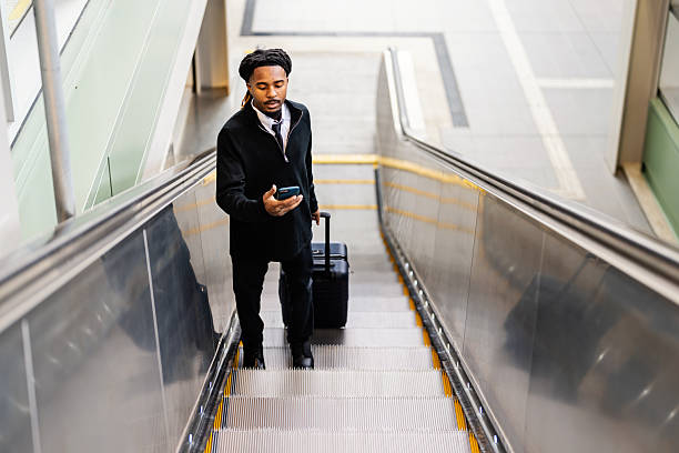 istock Young Businessman at Subway Station Riding Escalator 2251646474