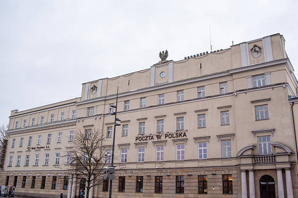 Lublin, Poland, November 25, 2025: The post office in Poland stands tall with its classic architecture. Rain clouds gather overhead as people walk by on the street.