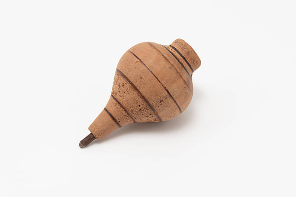istock Vintage wooden spinning top with painted lines, isolated on a clean white background. Studio shot. Symbolizes childhood, toy, nostalgia, and simple games 2251648954