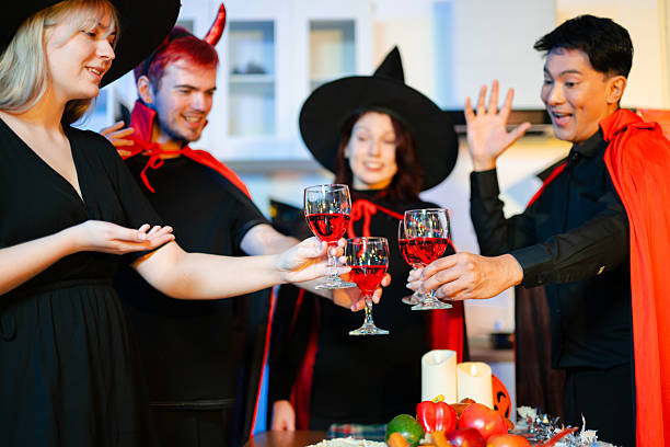 istock Halloween party react with surprise and laughter to spooky props like pumpkins and a ghost skeleton. Perfect seasonal fun, decor, and festive vibes. 2251652335