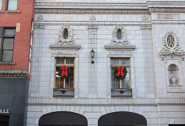 Christmas wreaths on the windows of a stone theater building in Wheeling, West Virginia