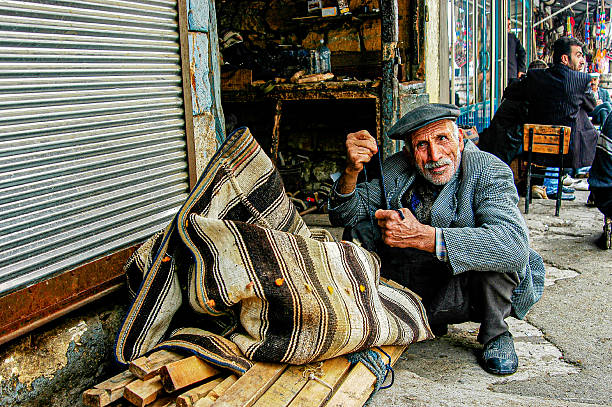 Adıyaman, Türkiye - April 07, 2005: In the old market of Adıyaman, a man was repairing a donkey saddle.