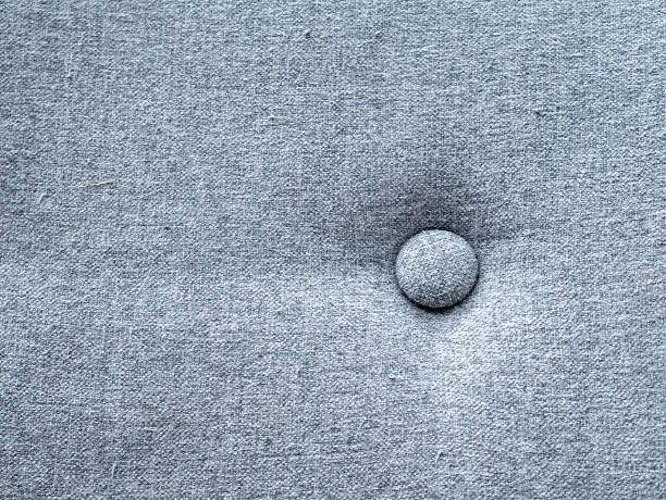 istock Button on Gray Fabric: Single Round Fastener on Soft Cloth Material Close-up Minimalist Textile Detail 2251662707