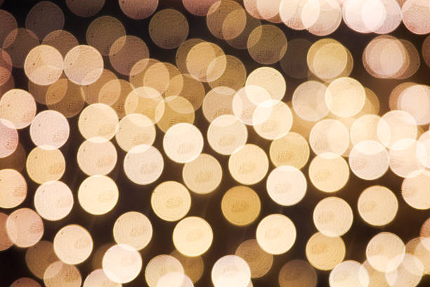 Soft, warm golden bokeh lights creating an abstract and festive background. Ideal for themes such as Christmas, holidays, celebration, luxury, elegance, and atmospheric lighting. Perfect for use in design, advertising, greeting cards, and digital graphics.