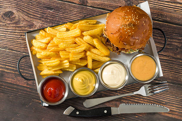 Slow-cooked beef brisket burger served with fries and sauces