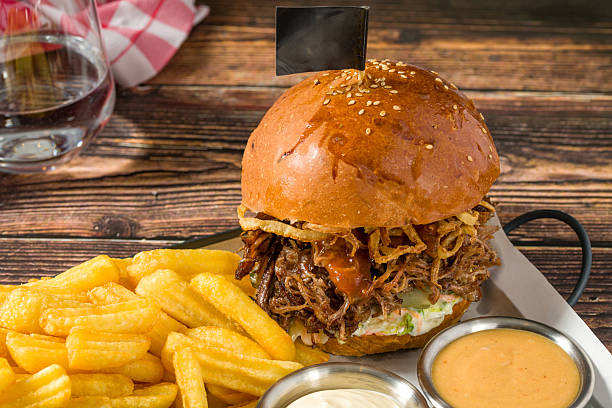 Slow-cooked beef brisket burger served with fries and sauces