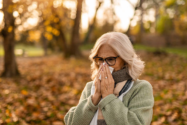 istock Senior woman having a cold while in the park 2251671765