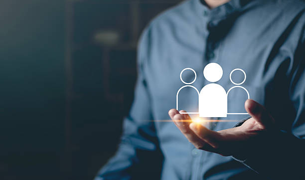 istock Human resources, leadership, recruitment, workforce management, collaboration, and people-centric business solutions  business professionals are holding the digital team icon in their hands. 2251671881