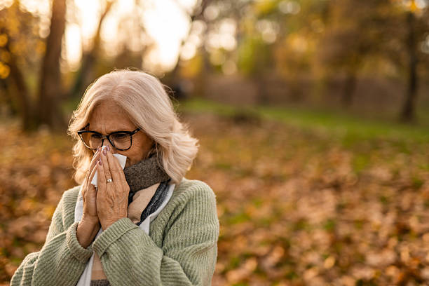 istock Senior woman having a cold while in the park 2251672003