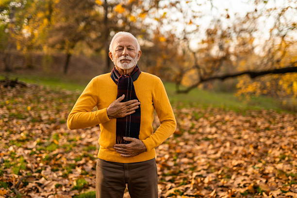 istock Senior man meditating in the park 2251672274