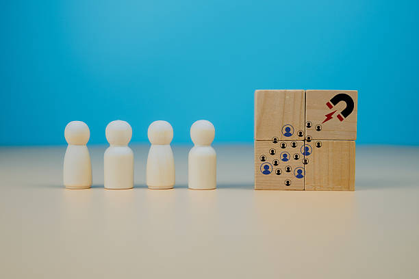 istock Lead generation and customer magnet concept. Wooden cube with magnet icon attracting user symbols, representing marketing funnel, organic reach, audience growth, and brand loyalty. 2251673640