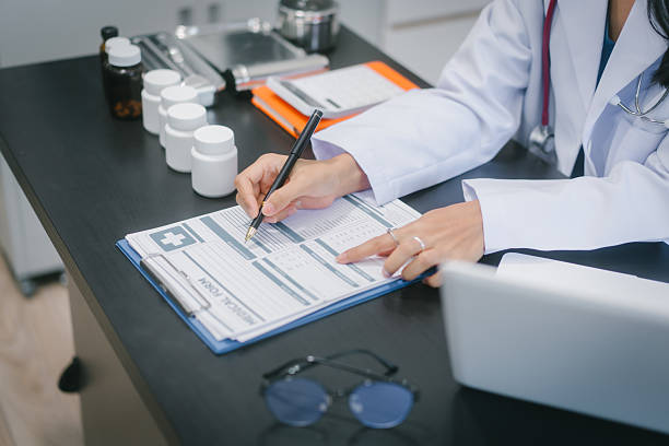 istock Asian female doctor using laptop for teleconsultation and checking patient's EHR record, wearing glasses,demonstrating modern healthcare,online medical services  professional expertise in hospital 2251676367