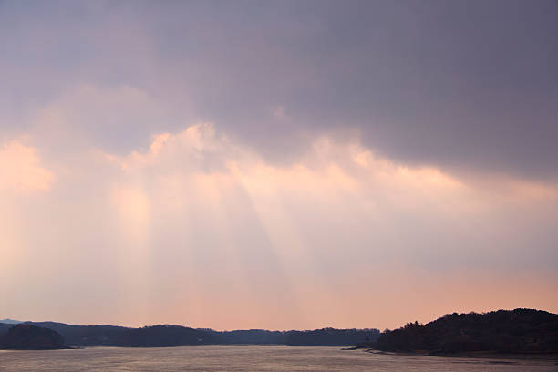 The sun shining through the cloudy morning clouds