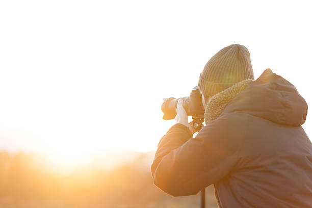 istock Photographer Facing the Rising Sun at Dawn 2251683326