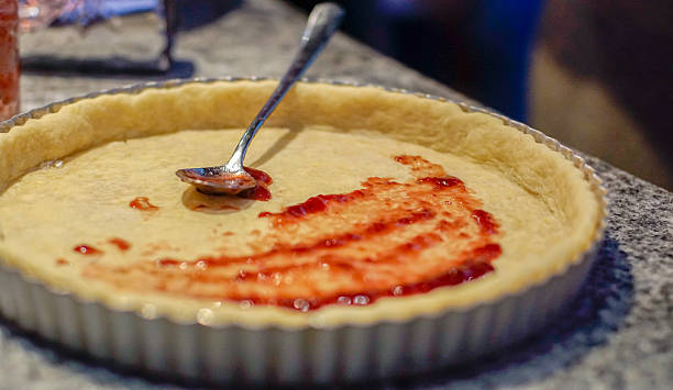 istock Jam Being Spread on Unbaked Tart Crust 2251689464