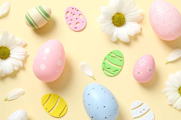istock Easter eggs and decoration with flowers on color background, top view 2251689802