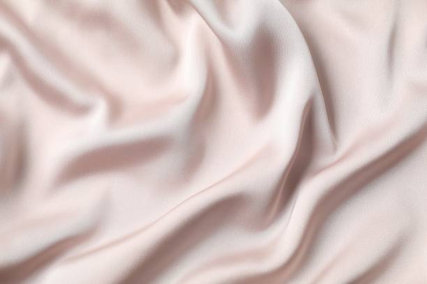 istock Beige silk satin. Shiny smooth fabric. Soft folds. Luxury background with space for design. Flat table, top view 2251694508