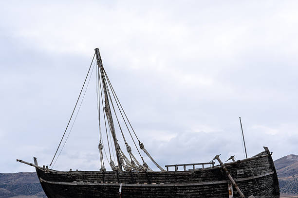 istock Abandoned Old Wooden Shipwreck on Land Under Gloomy Sky. 2251695508