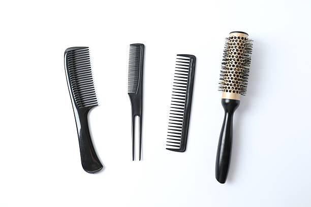 Professional combs and hairdresser tools on white background, top view