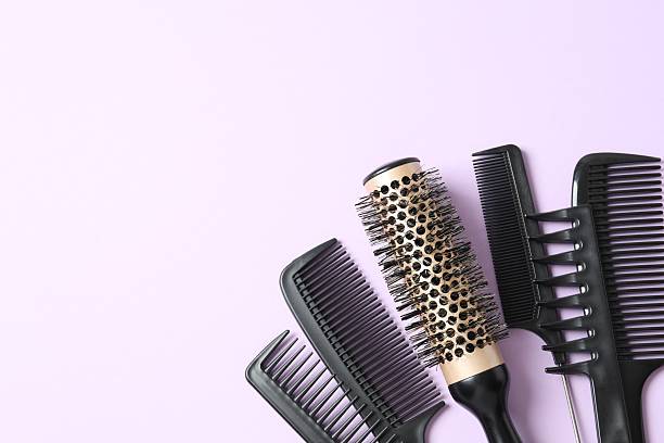 istock Professional combs and hairdresser tools on color background, top view 2251696777