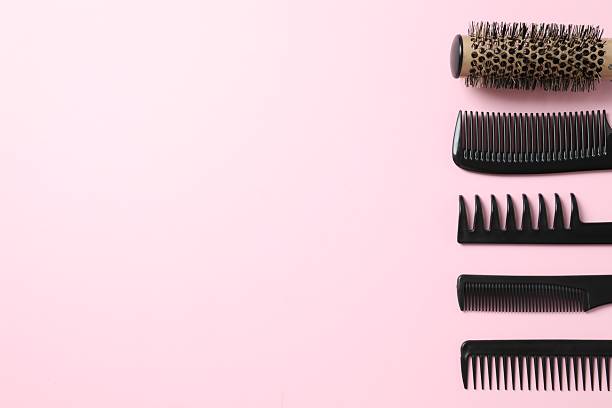 istock Professional combs and hairdresser tools on color background, top view 2251696799
