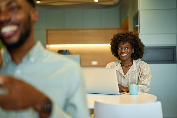 istock Smiling woman working at laptop in modern office space 2251696918