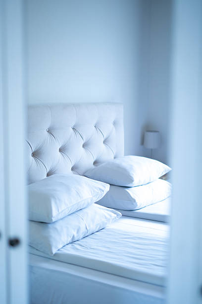 istock Clean hotel room with white tufted headboard and pillows. Stock image 2251699059
