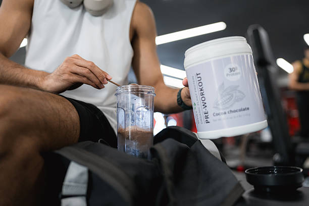 istock Fit Man Drinking Pre-Workout Whey Protein Shake, Sitting Confidently on a Bench Before His Exercise 2251699886