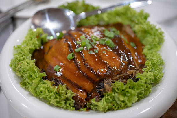 Meat slices with grana cheese on top, romaine lettuce and balsamic vinegar on top, served in fine dining