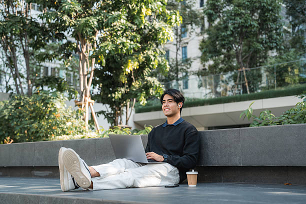 istock Young man smiling at his smartphone while listening to mindfulness podcast 2251704022